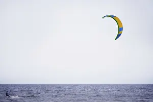 Blue Horizon View Drucke: A windsurfer skillfully navigates the ocean