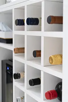 Architectural Style Details Drucke: Wine bottles in cellar in modern kitchen
