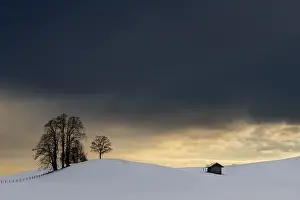 Snowy Countryside Scene Drucke: Winter landscape against a dramatic sky