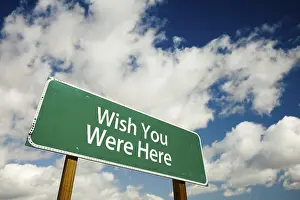 Deserted Street Sign Image Drucke: Wish you were here road sign with dramatic clouds and sky