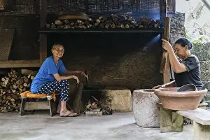 Women In The Kitchen Drucke: Two women work in a rustic kitchen