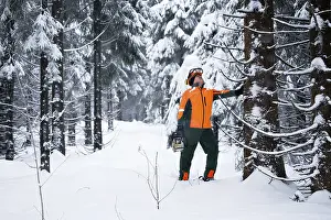 Snowy Landscape Photography Drucke: A woodcutter at work in the forest