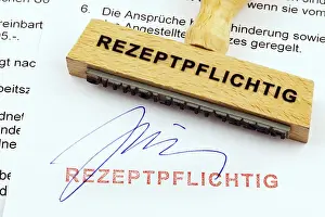 Wooden Stamp Drucke: A wooden stamp is placed on a document