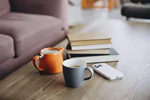 Minimalist Home Decor Drucke: A wooden table with a stack of books