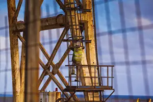 Alpine Sport Tourism Drucke: Worker climbing on a crane
