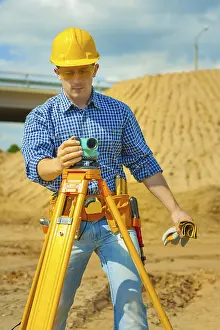 Construction Worker Drucke: A worker with theodolite