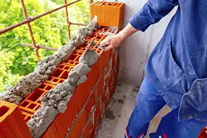 Construction Worker Drucke: Worker is using spatula, trowel