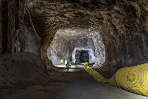 Rugged Mineral Walls Drucke: Workers exploring an underground rocksalt mine in Loule
