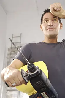 Safety Helmet Drucke: Workman holding a drill