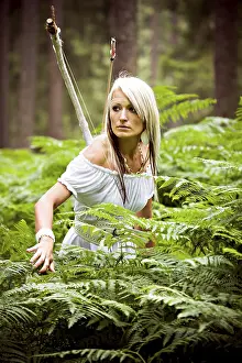 Tropical Forest Landscape Photo Drucke: A young amazon with a bow in the rainforest