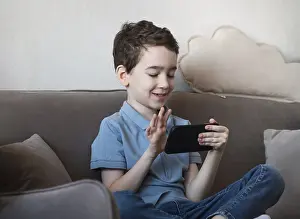 Modern Living Room Interior Drucke: A young boy is sitting on a couch