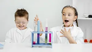 Classroom Learning Experience Drucke: Young child scientists having fun doing experiments laboratory