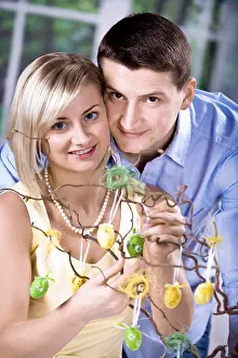 Christian Holiday Traditions Drucke: Young couple decorating for Easter