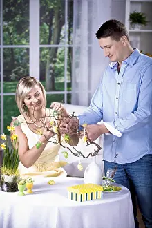 Christian Holiday Traditions Drucke: Young couple decorating for Easter