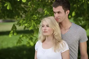 Blonde Woman Brunette Man Drucke: Young couple in a park in spring