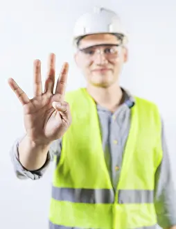 Young Engineer Drucke: Young engineer counting number four isolated