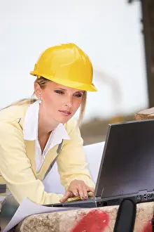 Construction Site Woman Drucke: Young female constructor at building site