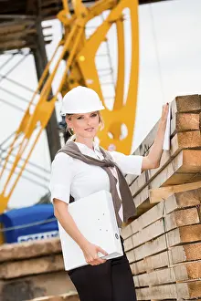 Construction Site Worker Drucke: Young female constructor at building site