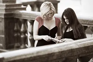 Young Female Students Drucke: Two young female students on campus between classes