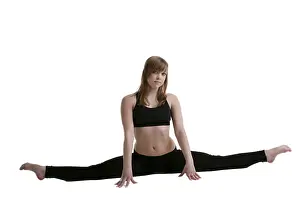 Female Gymnastics Drucke: Young gymnast in black show split isolated