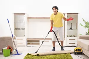Handsome Man Doing Housework Drucke: Young handsome man doing housework