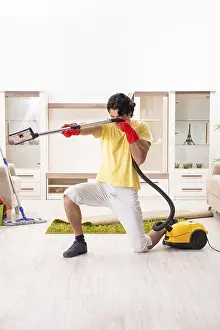 Handsome Man Doing Housework Drucke: Young handsome man doing housework