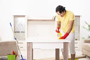 Handsome Man Doing Housework Drucke: Young handsome man doing housework