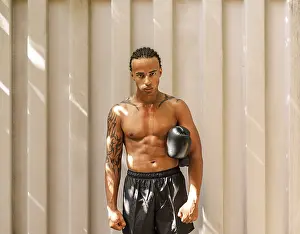 Kickboxer Portrait Drucke: Young kickboxer standing at a wall after training looking at the camera