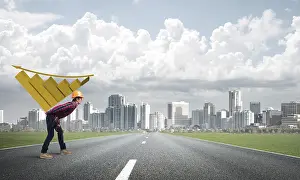 Young Construction Worker Drucke: Young man builder carrying growing graph on his back