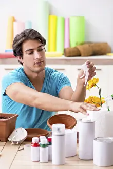 Studio Photography Art Drucke: Young man decorating pottery in class