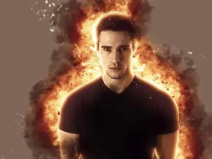 Man Looking At Camera Drucke: Young man with fire explosion or flame burst behind him
