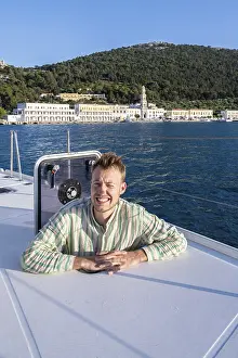 Symi Island Greece Drucke: Young man looking out of hatch