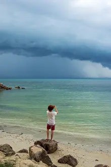 Southeast Asia Weather Drucke: Young man standing on the beach
