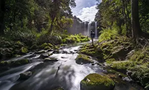 Young Man In Front Of Waterfall Drucke: Young man standing in front of waterfall