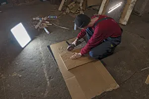 German Handicrafts Drucke: Young man working with an angle grinder in his workshop
