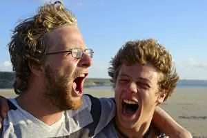 Daytime Portrait Photography Drucke: Two young men shouting and embracing