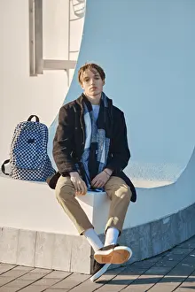 Self Confident Male Drucke: Young student with backpack in old wool coat