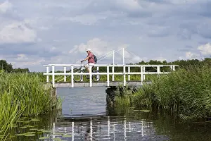Gerahmter Druck : Radfahrer. Alter radelt über Brücke in Weerribben; Alter fährt Fahrrad